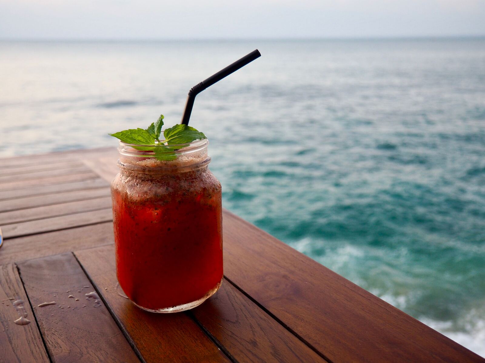 Tropical cocktail on a table by the ocean