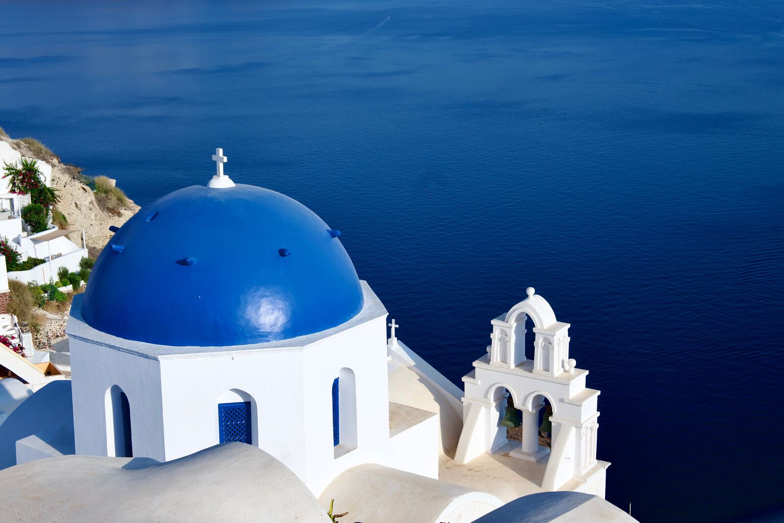 Iconic blue-domed churches overlooking the Aegean Sea in Santorini, Greece