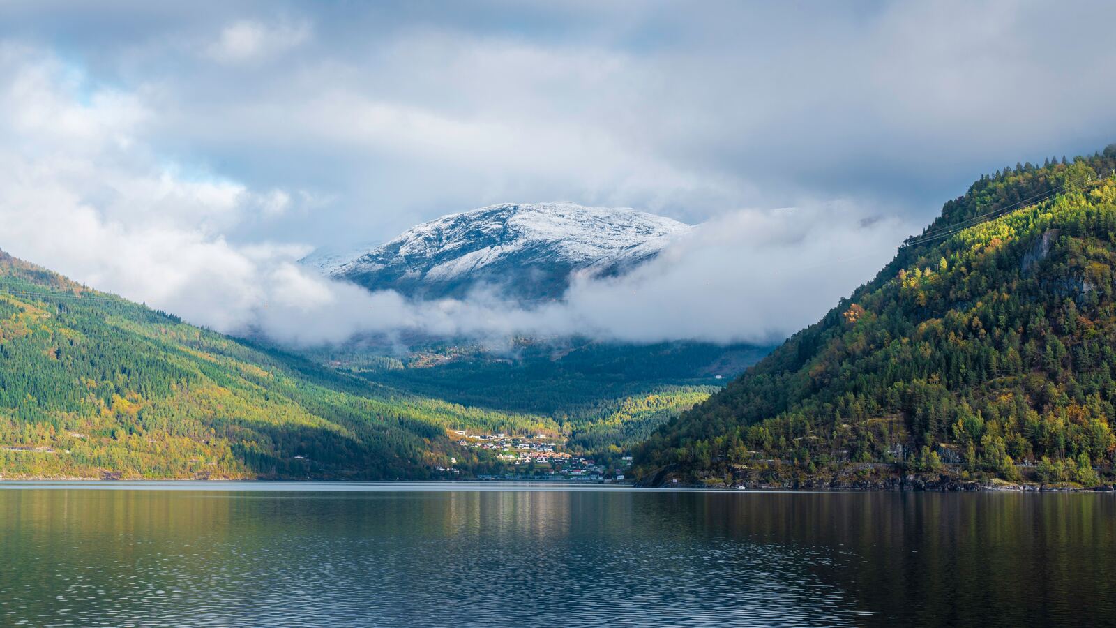 Norwegian fjord and mountains under low cloud